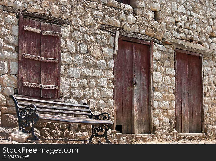 Very old stone Greek house and bench, Epidaurus, Peloponnese, Greece. Very old stone Greek house and bench, Epidaurus, Peloponnese, Greece