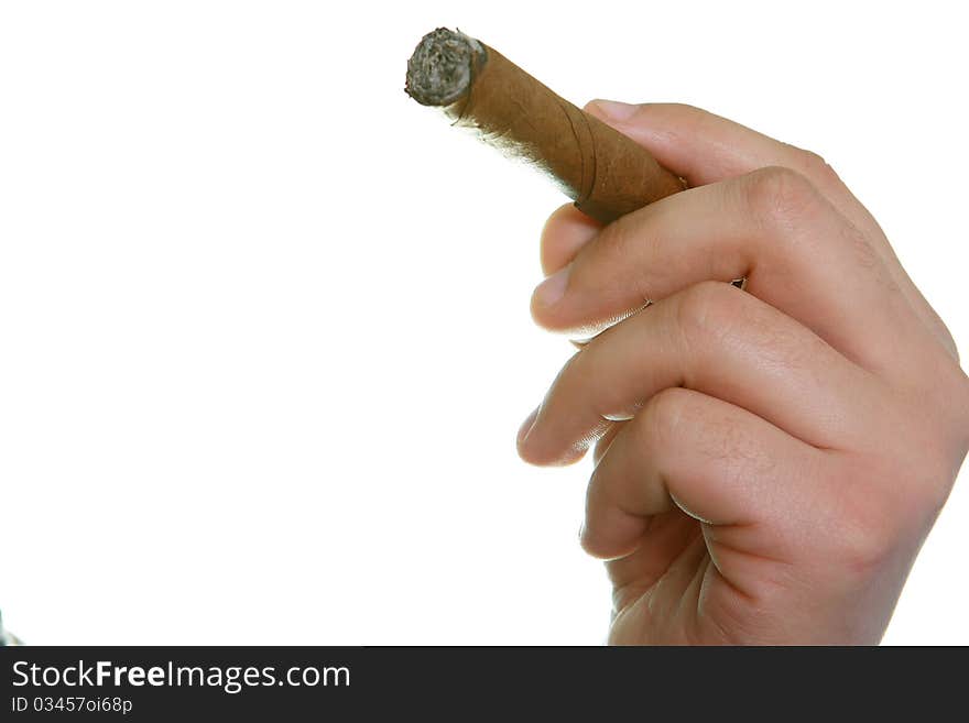 The man's hand holds fingers a cigaret on a white background. The man's hand holds fingers a cigaret on a white background