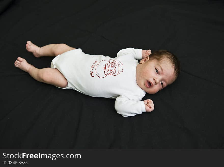 Wake-up little baby girl holding out her arms and fits