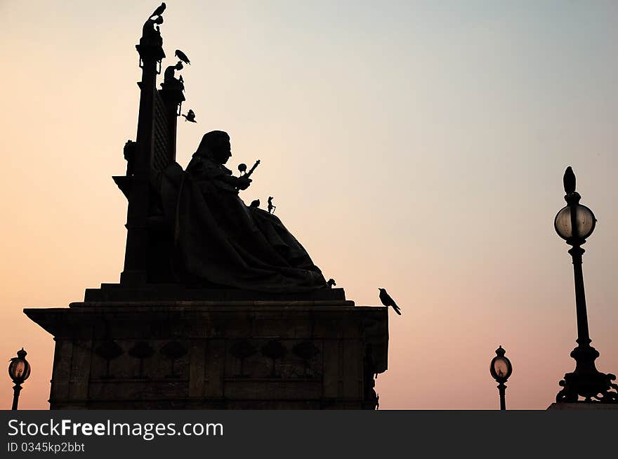 Silhouette of statue of queen Victoria at Victoria Memorial, Kolkata, during sunset. Silhouette of statue of queen Victoria at Victoria Memorial, Kolkata, during sunset