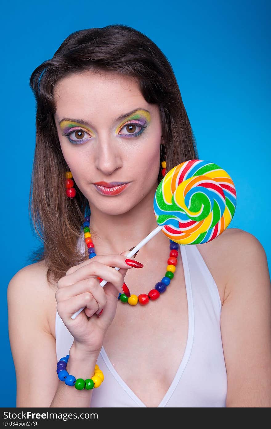 Portrait of beautiful girl with big lollipop