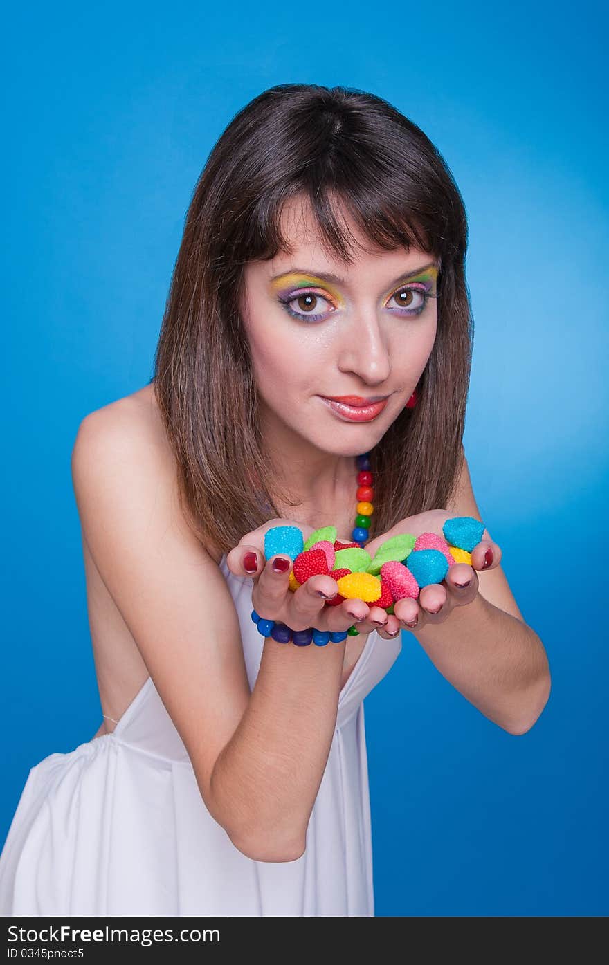 Portrait of beautiful girl offering candies. Portrait of beautiful girl offering candies