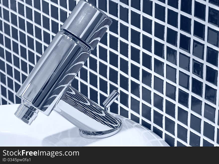 Faucet in dark blue - white tiled bathroom. Faucet in dark blue - white tiled bathroom