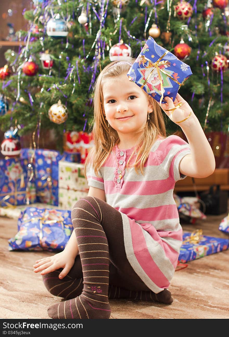 Little girl under christmas tree. Little girl under christmas tree