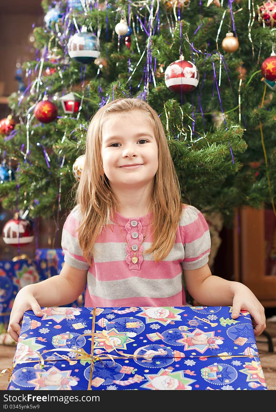 Little girl under christmas tree. Little girl under christmas tree