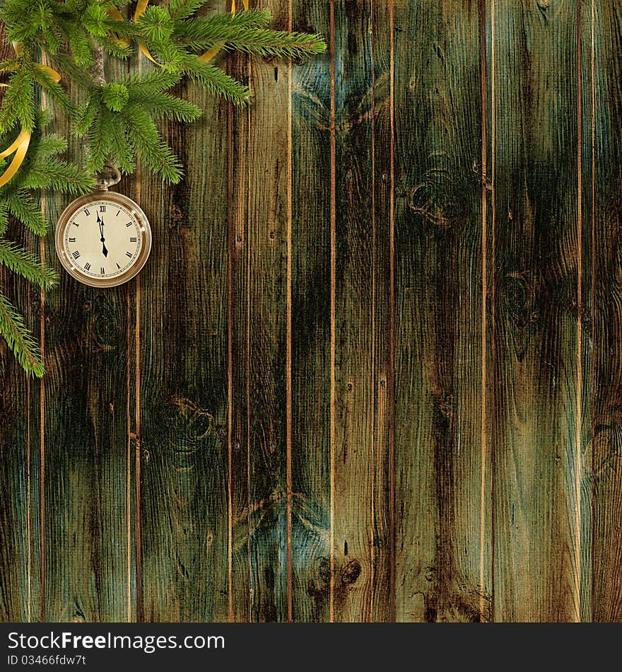 Card for the holiday with branches and clock on the wooden background