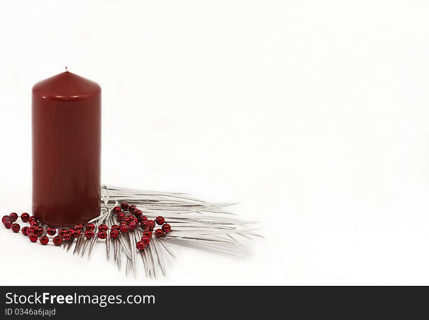 Red candle and silver leaves as a christmas decoration