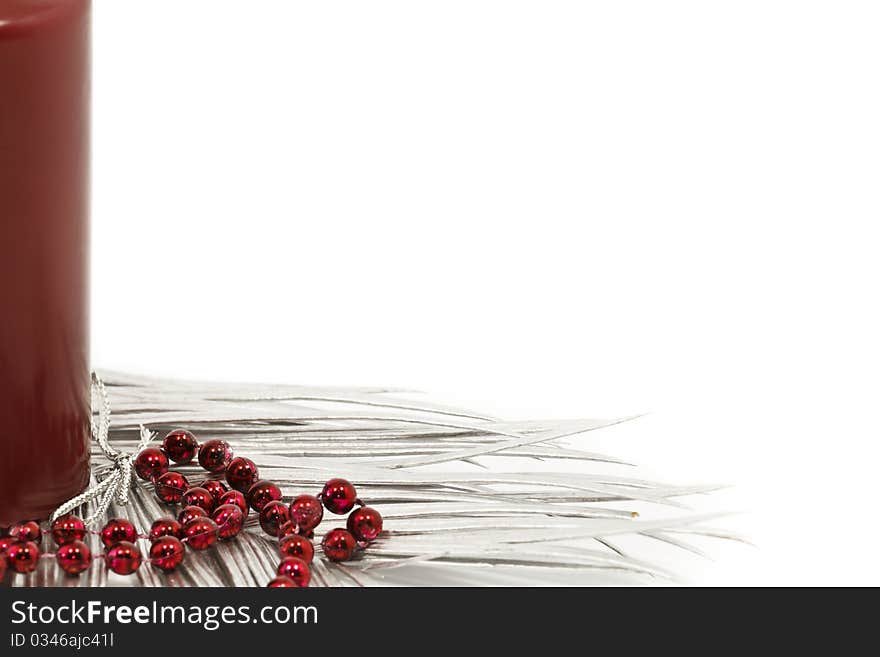 Red candle and silver leaves as a christmas decoration