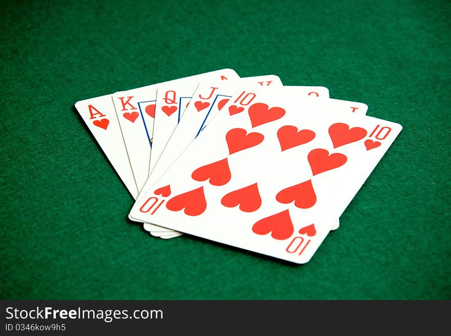 Playing cards on green background, heart poker