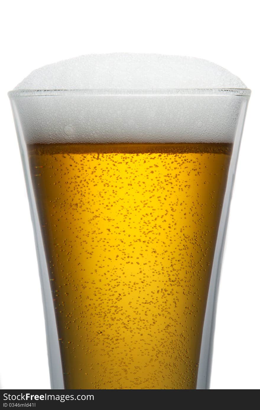 Beer into glass isolated on white