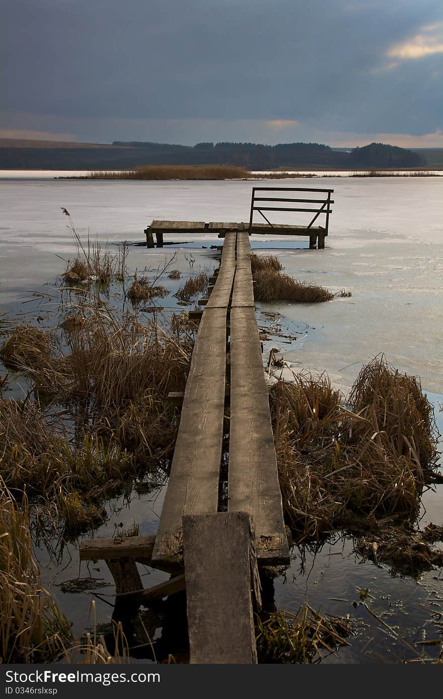 The bridge on the beautiful frozen lake. The bridge on the beautiful frozen lake.