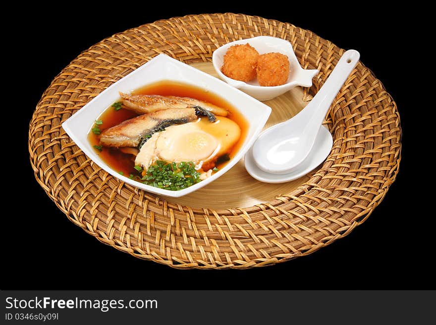 Japanese cuisine, soup with fried eggs and meat of an eel. Japanese cuisine, soup with fried eggs and meat of an eel