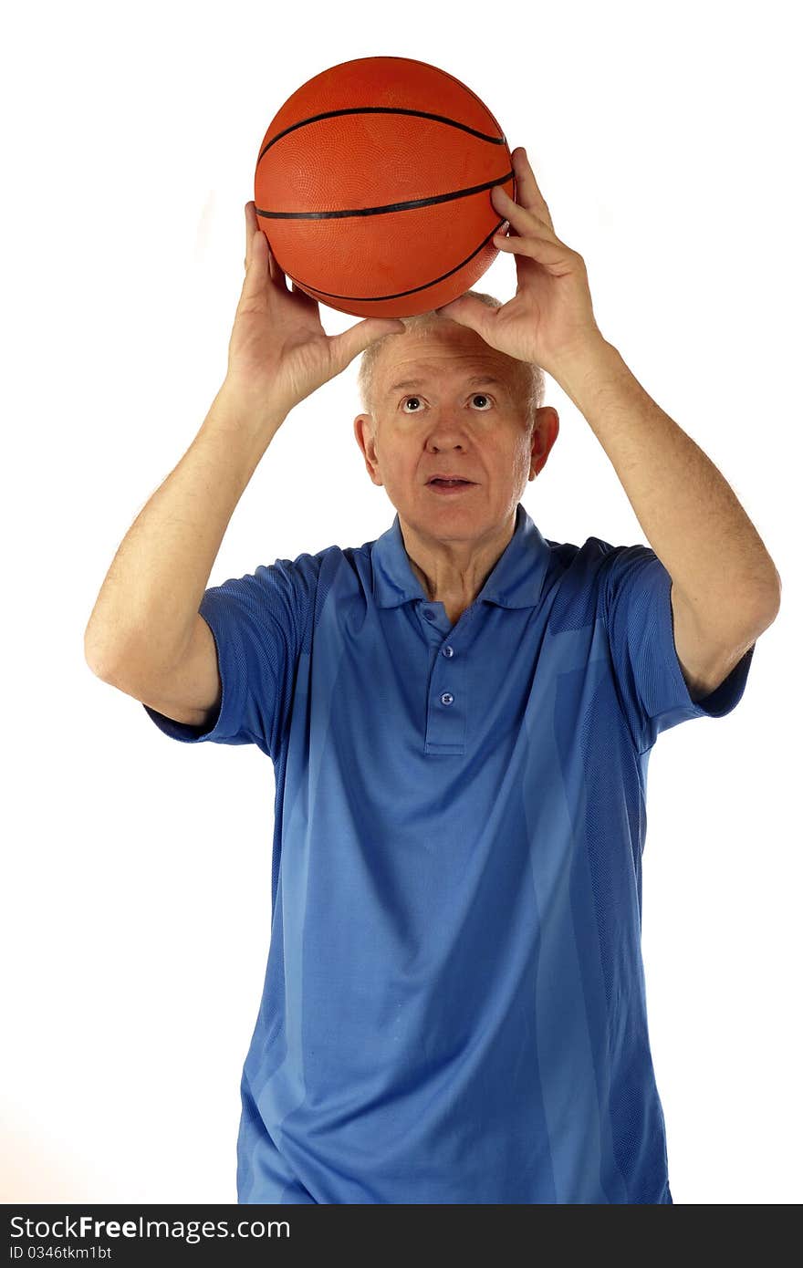 A senior man preparing a two-handed basketball shoot. Isolated on white. A senior man preparing a two-handed basketball shoot. Isolated on white.