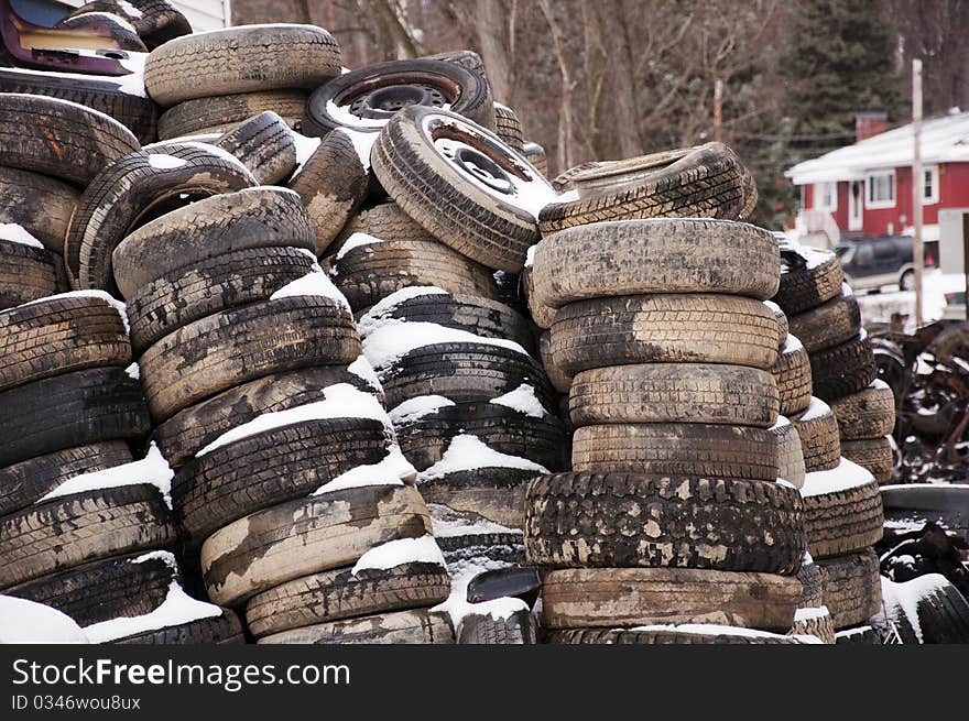 Old tires in a salvage yard in winter