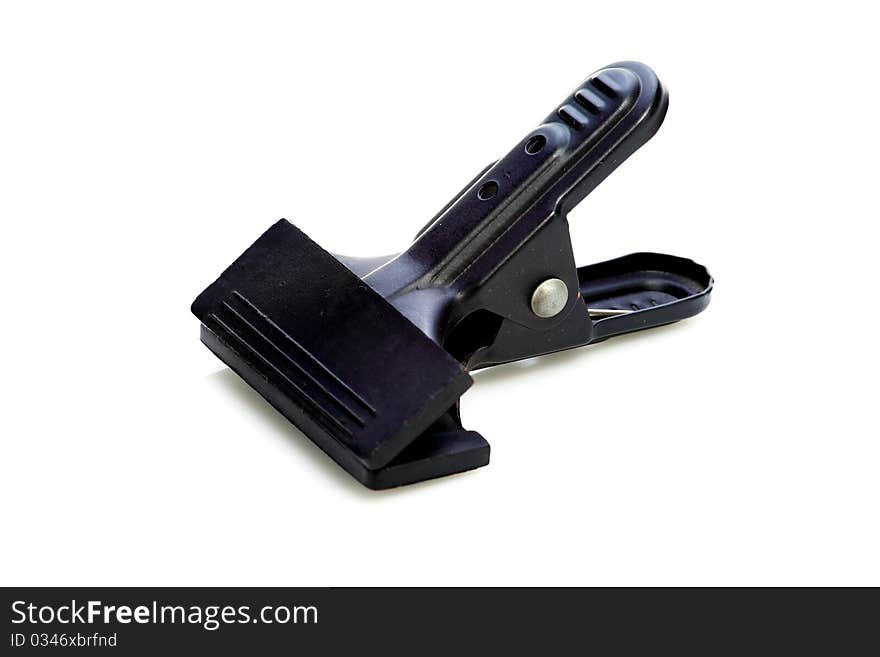 Black metal clamp on a white background. Black metal clamp on a white background