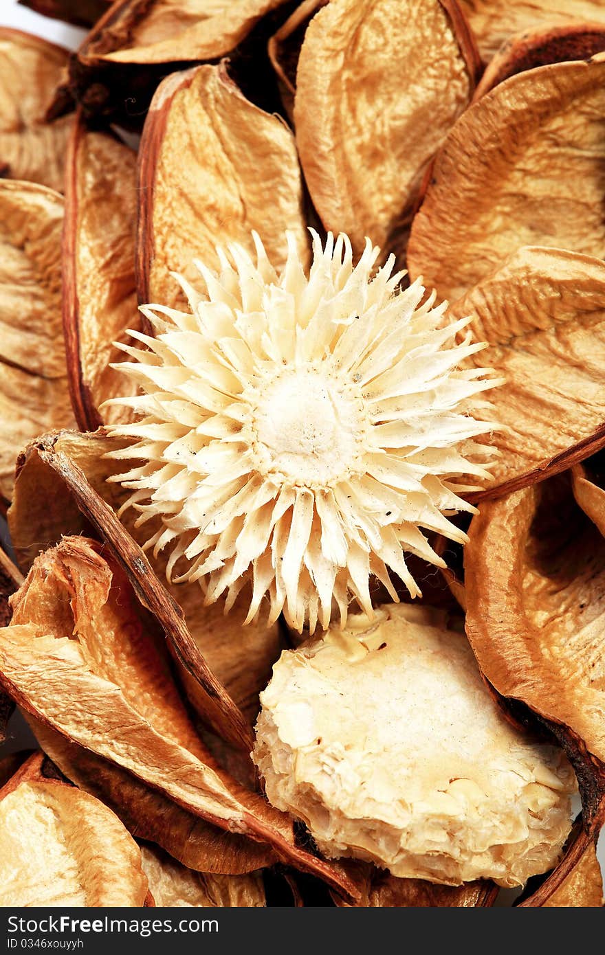 Closeup of a braon potpourri with a dry flower in the middle