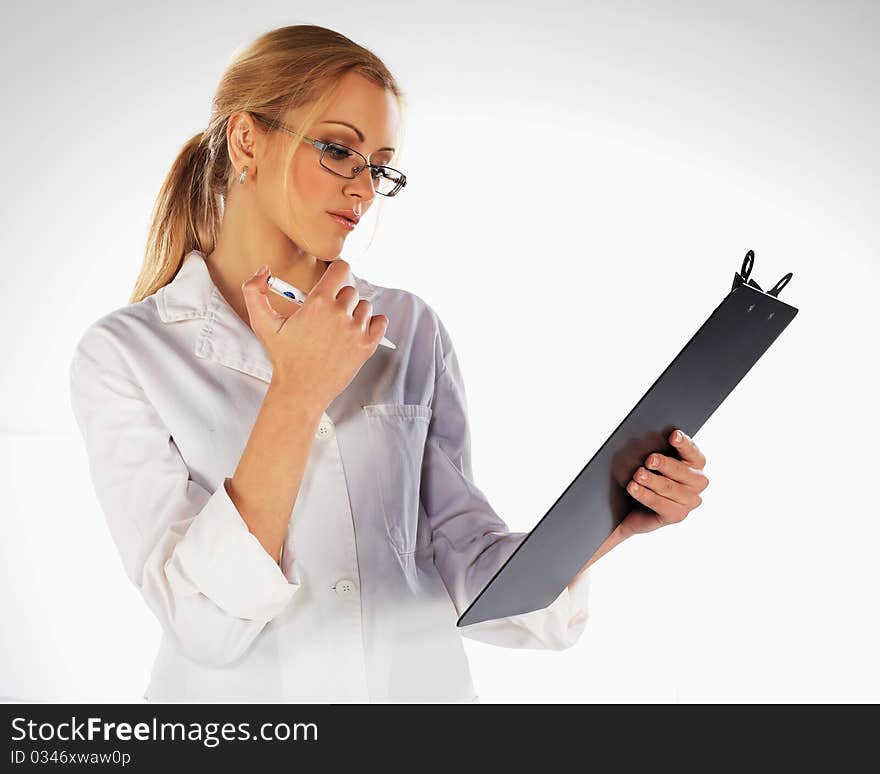 Nurse standing, taking notes and looking at medical charts. Nurse standing, taking notes and looking at medical charts