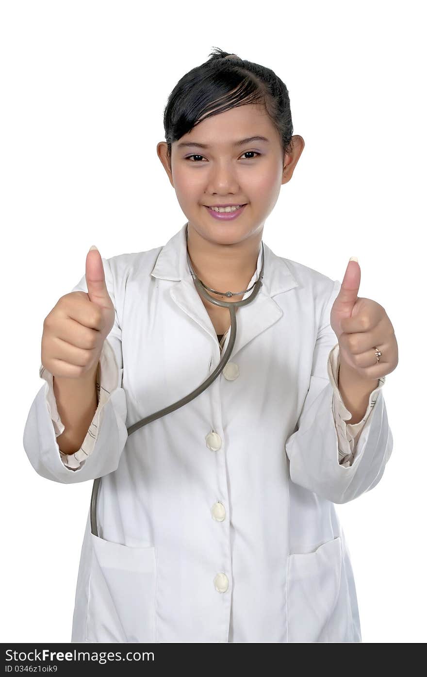 Beautiful young doctor show her thumbs and wearing white coat isolated over white background. Beautiful young doctor show her thumbs and wearing white coat isolated over white background