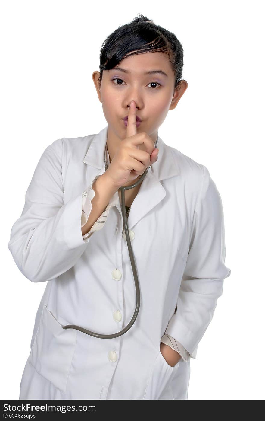 Beautiful young doctor say silent and wearing white coat isolated over white background. Beautiful young doctor say silent and wearing white coat isolated over white background