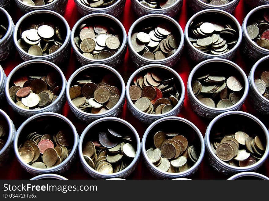 Money in tray with pedestal in temple