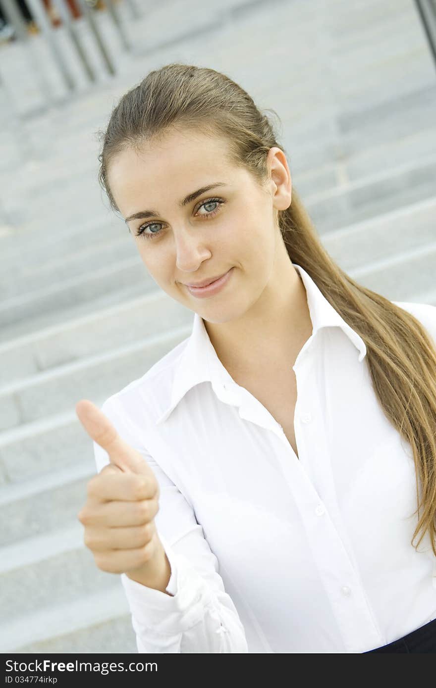 Young business woman shows a sign of OK. Young business woman shows a sign of OK.