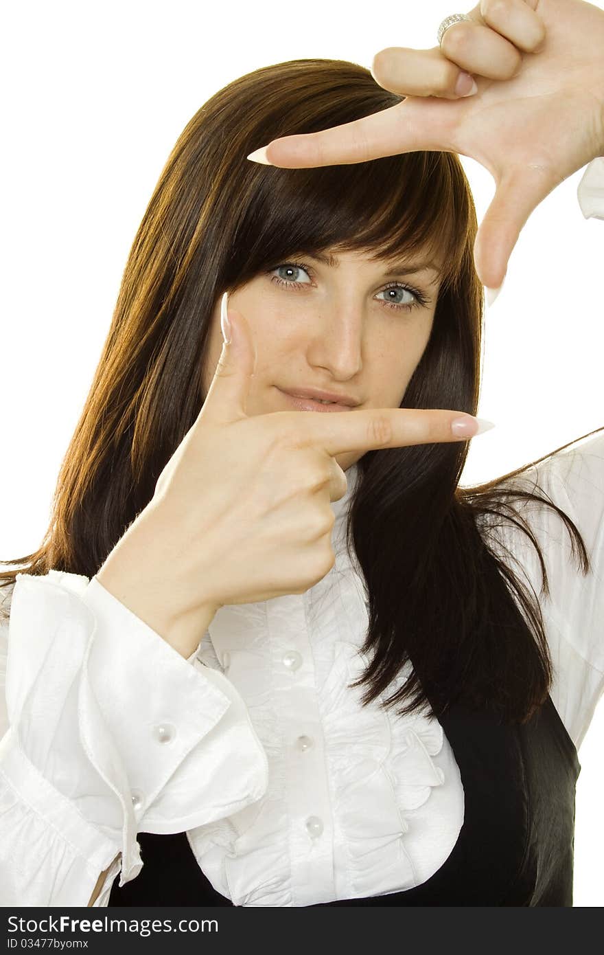 Young businesswoman looks through a frame made of hand. Young businesswoman looks through a frame made of hand