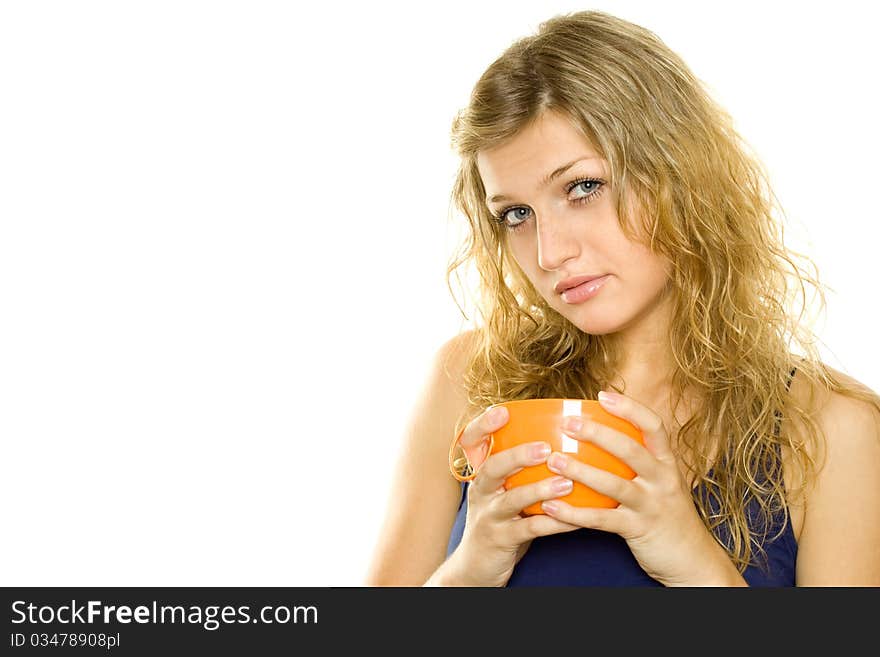 Pretty young woman with an orange cup of tea / coffee. Isolated on white background. Pretty young woman with an orange cup of tea / coffee. Isolated on white background