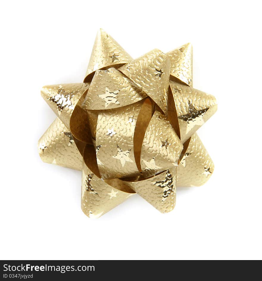 Golden star made from decorative ribbon isolated on white background