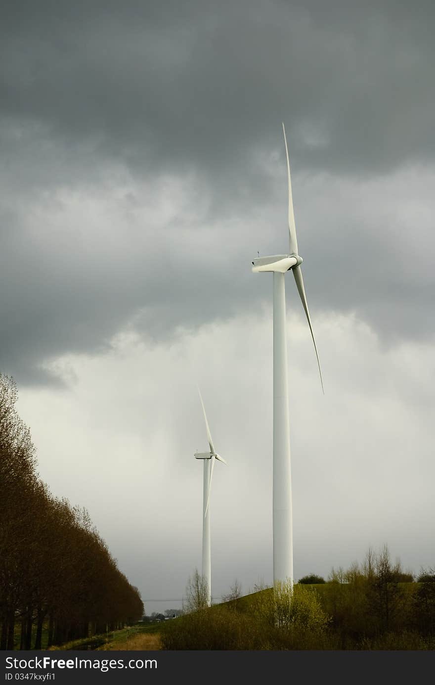 Dark clouds over renewable energy sources. Wind energy and solar energy in stormy wheather.