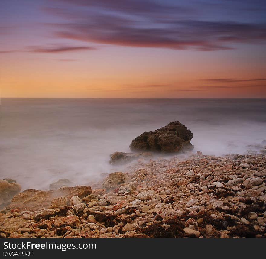 Sea coast at sunset the sun, the summer sea. Sea coast at sunset the sun, the summer sea