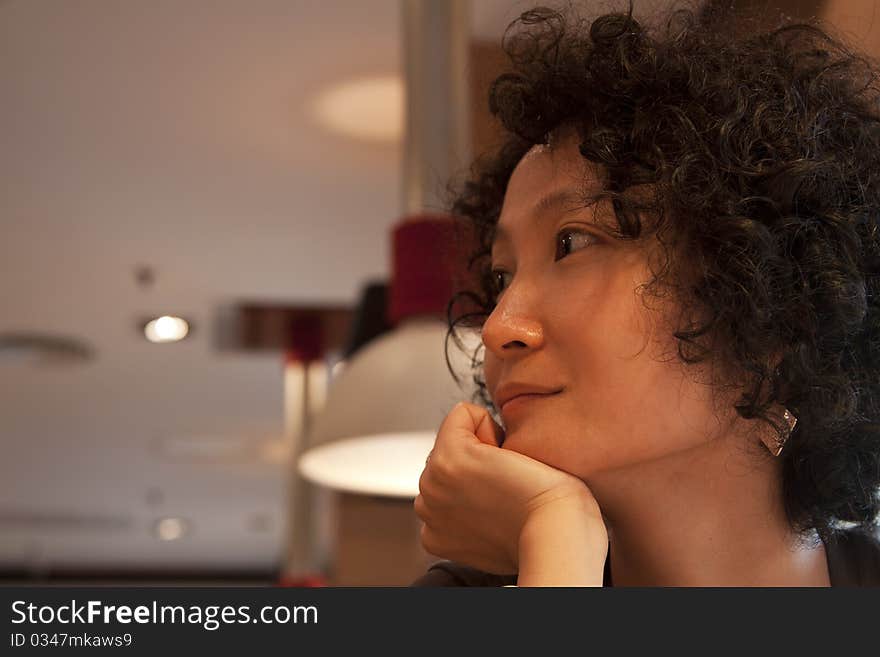 Portrait of a young Chinese woman in restaurant. Portrait of a young Chinese woman in restaurant