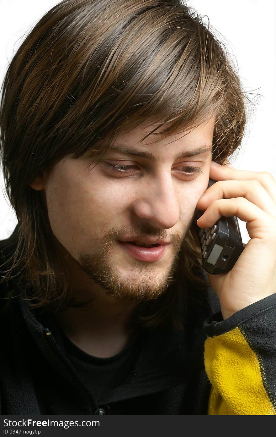 Bearded young men talking by telephone