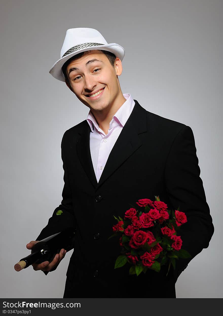 Romantic young man with flowers on a date