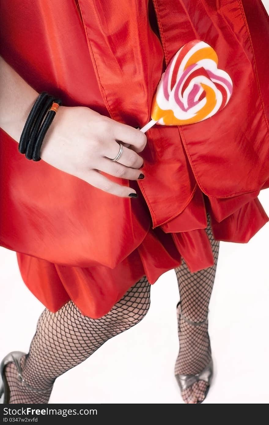 Woman in a red dress holds lollipop. Woman in a red dress holds lollipop