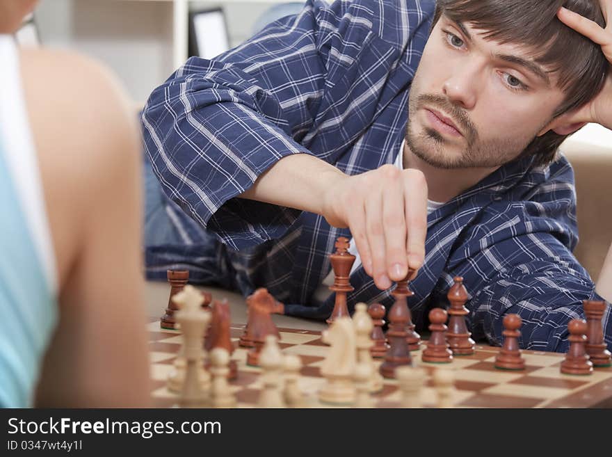 Couple Playing Chess At Home