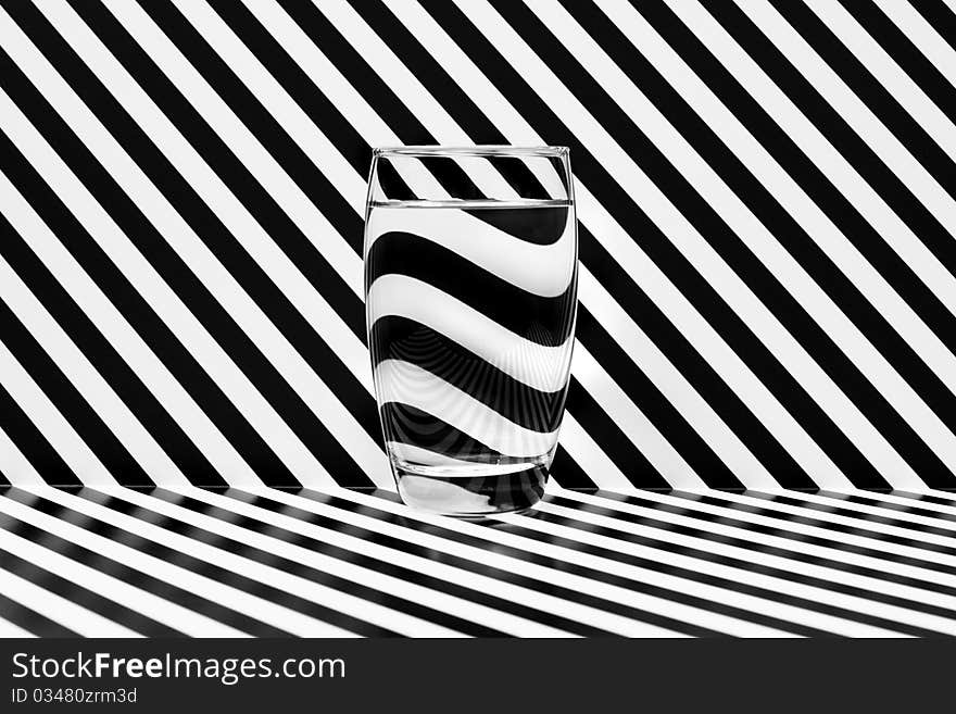 Reflections in a glass of water in black and white.