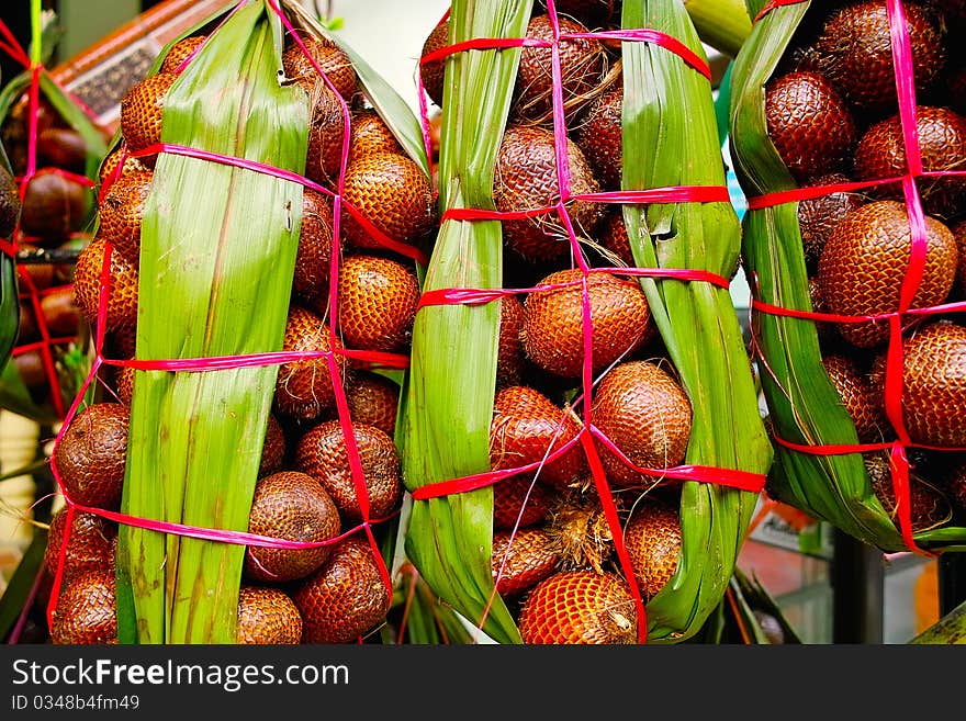 Snake fruit on a market packaged in natural leafs