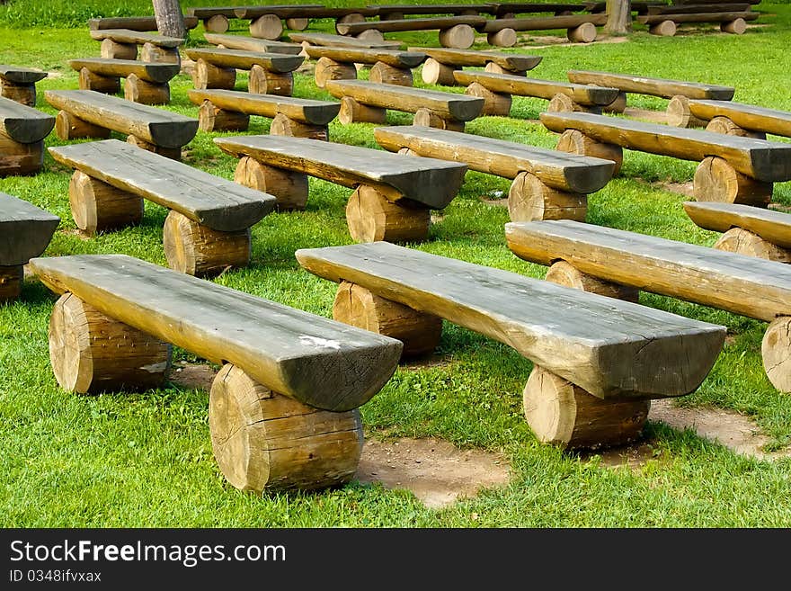 Outdoor wood seating on green lawn