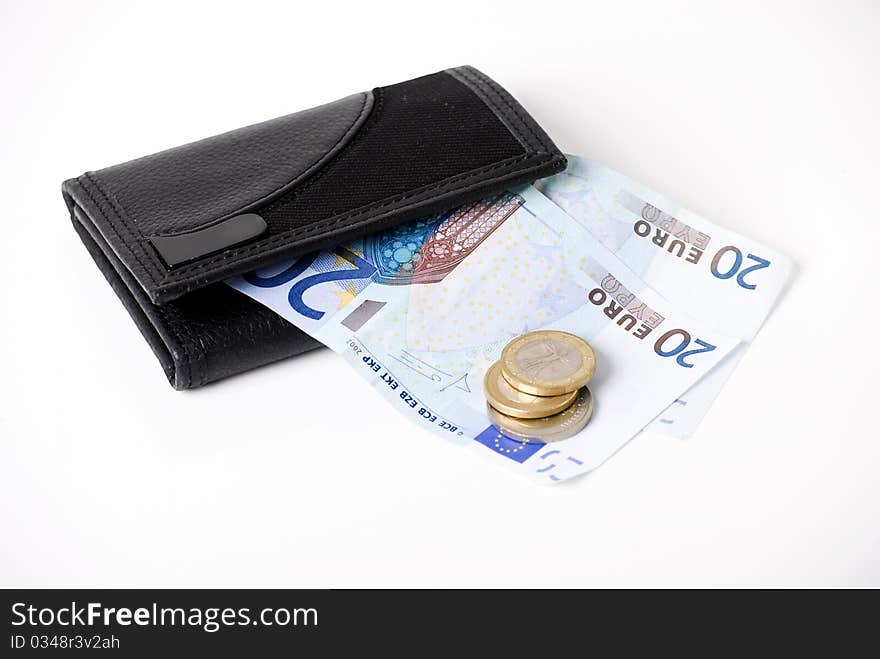 A horizontal image of euro notes sticking out of a black leather mans wallet. A horizontal image of euro notes sticking out of a black leather mans wallet