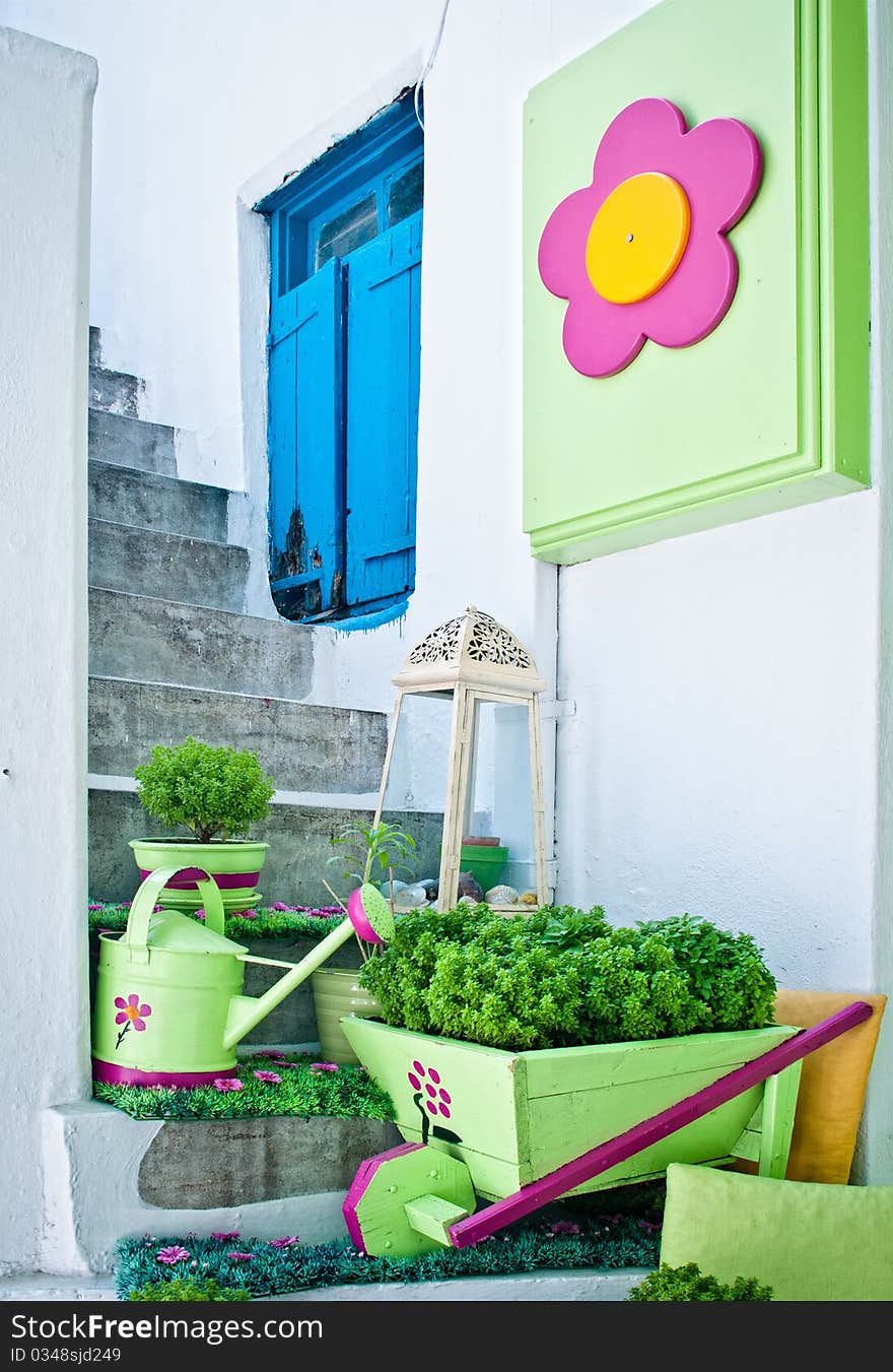 Pots Of Flowers On A White Staircase With A Wicket. Pots Of Flowers On A White Staircase With A Wicket