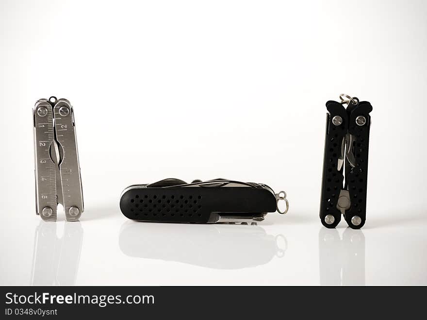 A horizontal image of three different multitools. A horizontal image of three different multitools