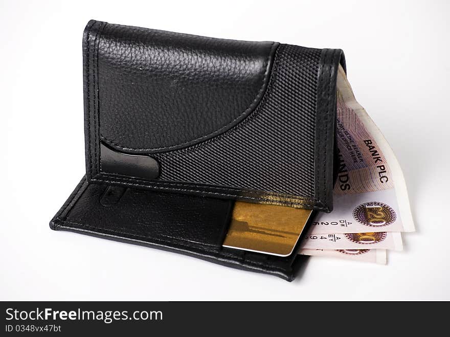 A horizontal image of bank notes sticking out of a black leather mans wallet. A horizontal image of bank notes sticking out of a black leather mans wallet