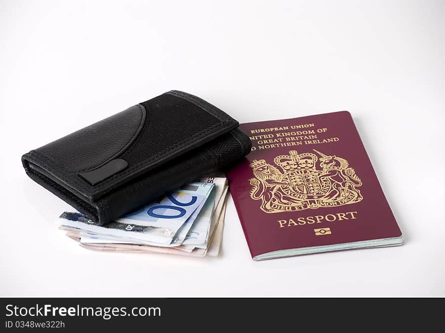 A horizontal image of bank notes sticking out of a black leather mans wallet with a passport. A horizontal image of bank notes sticking out of a black leather mans wallet with a passport