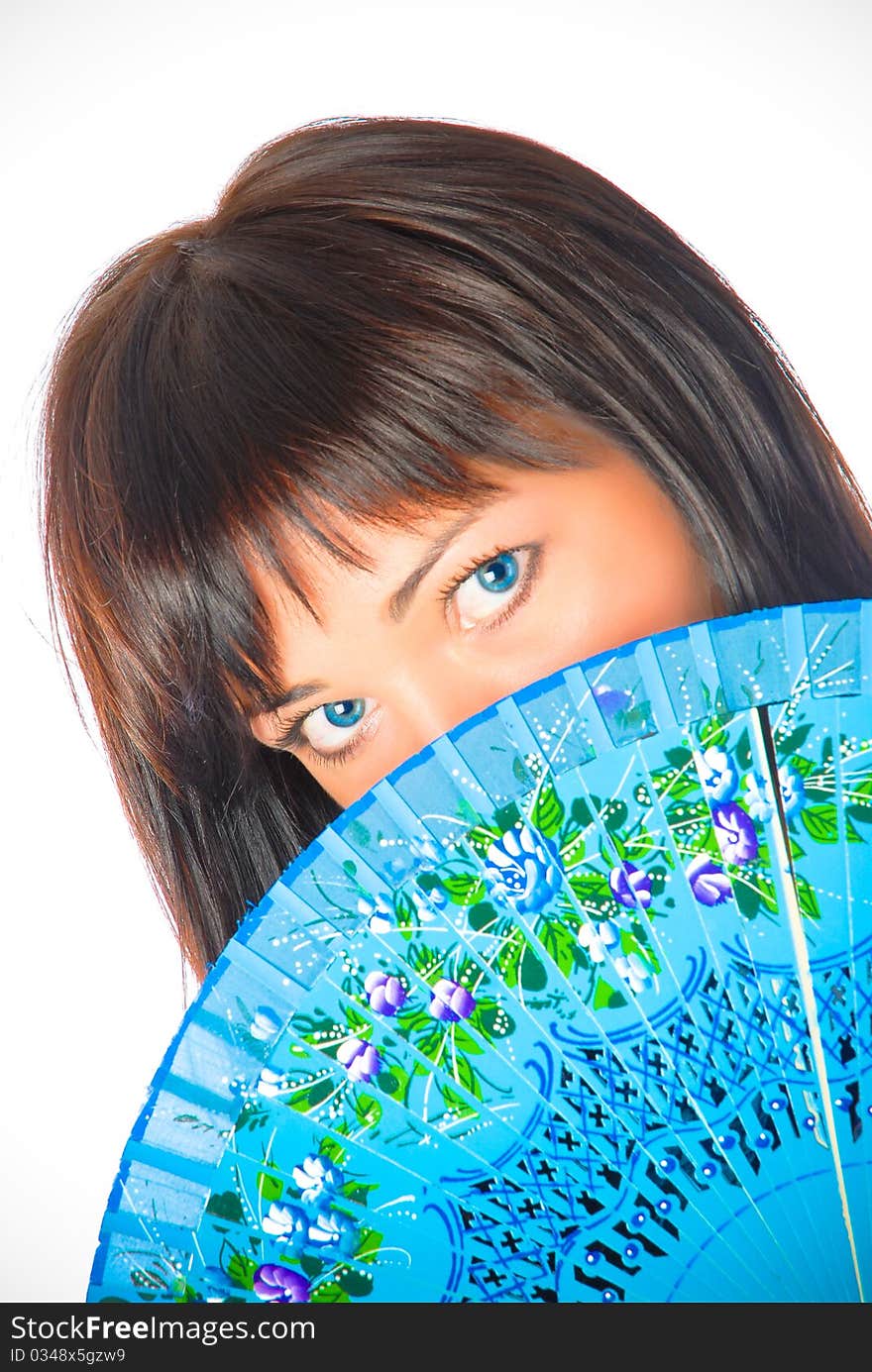 Beautiful brunette woman with blue eyes with a fan. Beautiful brunette woman with blue eyes with a fan