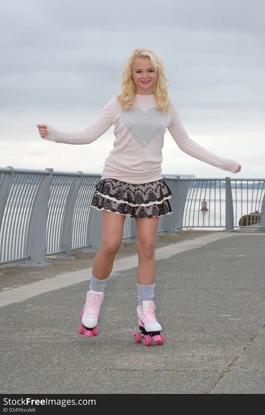 Image showing pretty young female on roller skates smiling