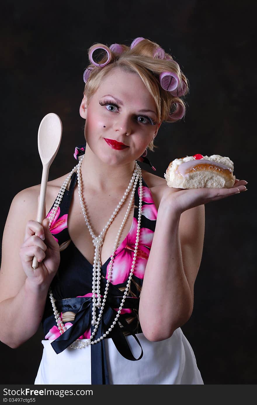 Photograph showing retro style 50s female posing against black with cream cake. Photograph showing retro style 50s female posing against black with cream cake