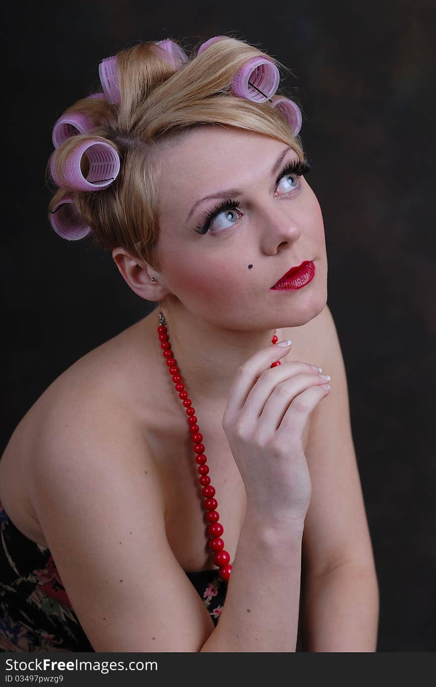 Photograph showing retro style 50s female posing against black. Photograph showing retro style 50s female posing against black