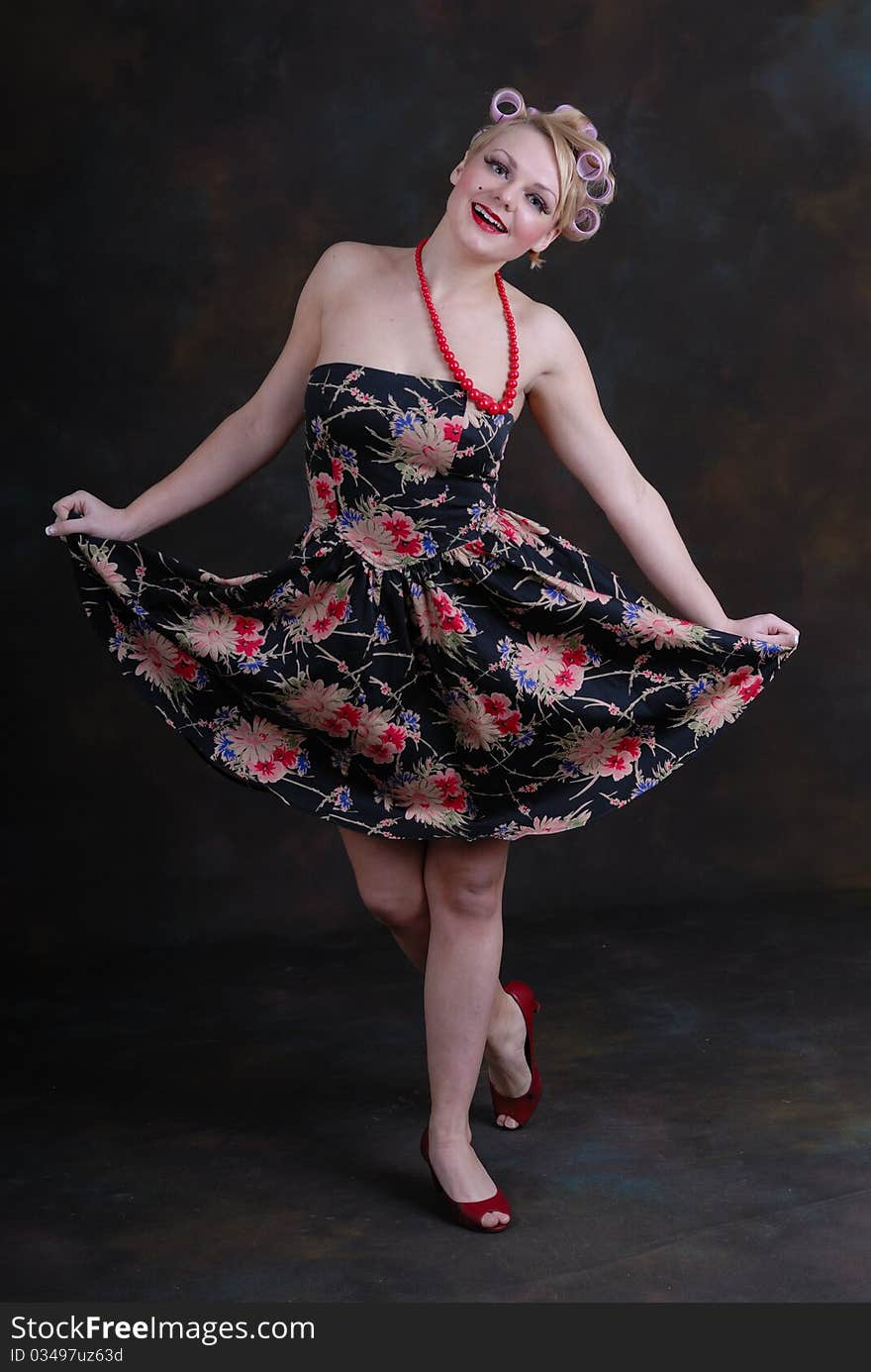 Photograph showing retro style 50s female posing against black. Photograph showing retro style 50s female posing against black