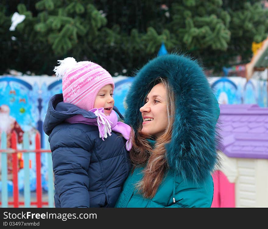 Mom and girl near a Christmas tree