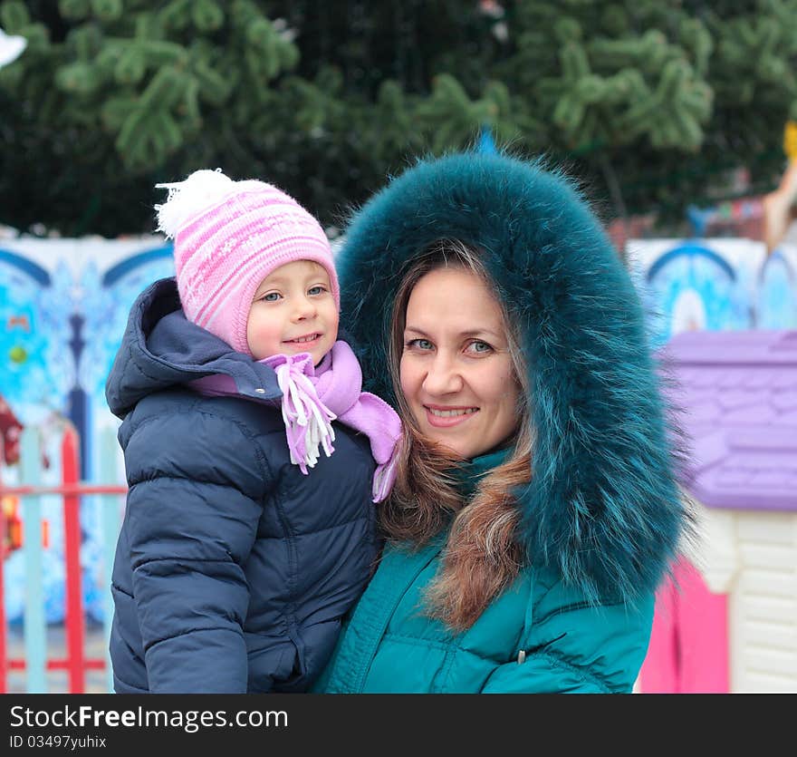 Mom and girl near a Christmas tree